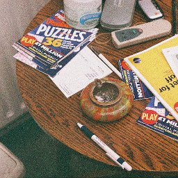 A side table with scattered puzzle books and an ashtray.